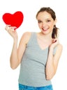 Girl with a heart-shaped pillow Royalty Free Stock Photo