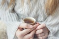 Girl heats hands about cup of tea