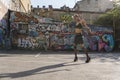 Girl on heels. Street punk or hipster girl on with pink dyed hair. Woman with piercing in nose, ears tunnels and unusual