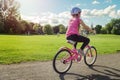 Girl in a helmet riding a bicycle