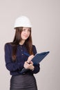 Girl a helmet writes in pencil folder