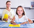 Girl helping mom dusting Royalty Free Stock Photo