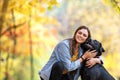 Girl with her dog labrador in autumn sunny park Royalty Free Stock Photo