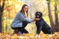 Girl with her dog labrador in autumn sunny park Royalty Free Stock Photo