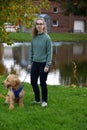 Teenage girl makes a walk with her little dog Royalty Free Stock Photo