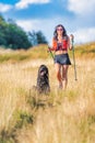 Girl with her dog on a Nordic walking trip Royalty Free Stock Photo