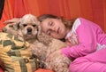 Girl and her dog sleeping together Royalty Free Stock Photo