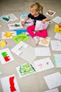 Girl with her drawings on the floor