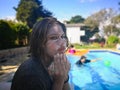 Girl with her face covered in sunscreen and expression of worry, consternation