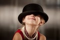 Girl with her face in her hat Royalty Free Stock Photo