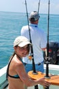 Girl and her father fishing on a boat