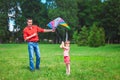 The girl and her father play with a kite. Royalty Free Stock Photo