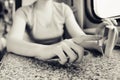 Girl in her hands holds a mobile phone and pokes her finger in the journey by train and train in the car.