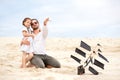 Girl with her happy father flying kite coast ocean