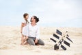 Girl with her happy father flying kite coast ocean