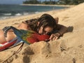 Girl and her Macaw at the beach