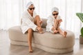 Girl And Her Mom Wearing Bathrobes And Sunglasses Doing Pedicure At Home Royalty Free Stock Photo