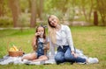 Girl And Her Mother Blowing Bubbles Having Fun In Park Royalty Free Stock Photo