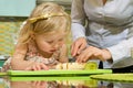 Girl and her mother cutting fruits