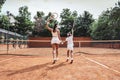 Girl with her mother play tennis on the tennis court Royalty Free Stock Photo