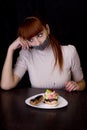 Girl with her mouth sealed with adhesive tape and cakes Royalty Free Stock Photo