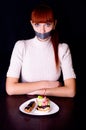 Girl with her mouth sealed with adhesive tape and cakes Royalty Free Stock Photo