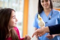 Girl with her nymph parrot in veterinary clinic Royalty Free Stock Photo