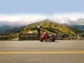 Girl with her scooter enjoying beautiful view of mountains scene Royalty Free Stock Photo