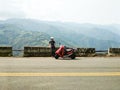 Girl with her scooter enjoying beautiful view of mountains scene Royalty Free Stock Photo