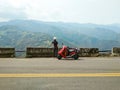 Girl with her scooter enjoying beautiful view of mountains scenery Royalty Free Stock Photo