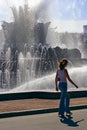The girl, her shadow and a fountain Royalty Free Stock Photo