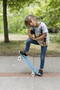 Girl with her skateboard in a park.