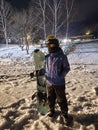 A girl with her snowboard and her first practice for snowboarding at Niseko illage, Sapporo , Japan