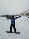 A girl with her snowboard and her first practice for snowboarding at Niseko illage, Sapporo , Japan Royalty Free Stock Photo