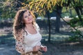 Girl, in her sunglasses with a beautiful smile poses in the park Royalty Free Stock Photo