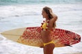 Girl with her surfboard at the beach