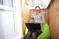 Girl hid, closed in self-isolation. Remote working at home on the laptop