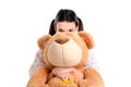 Girl hiding behind the big teddybear.