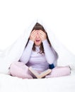 Girl hiding under cover in her bed