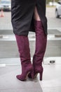 Girl in high red boots, a coat in the office Royalty Free Stock Photo