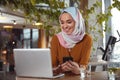 Girl In Hijab. Beautiful Muslim Woman Portrait. Model Sitting In Cafe And Working On Laptop.