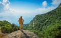 Girl hiker with backpack on a rock Royalty Free Stock Photo