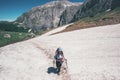 Girl hiker climbing on mountains glacier with backpack