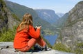 Girl hiker looking at the fjord