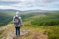 Girl hiker is looking at panoramic Guinness Lake Lough Tay valley -  a movie and series location, such as Vikings. Close to Royalty Free Stock Photo