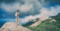 Girl hiker on a rock enjoy the sunny valley Royalty Free Stock Photo