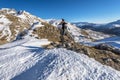 Girl hiker is staying in the stone facing to the panoramic view of upper Tena Valley in Spanish Pyrenees in early winter time. Royalty Free Stock Photo