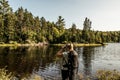 Girl hiking in the Forest near lake in La Mauricie National Park Quebec, Canada on a beautiful day Royalty Free Stock Photo