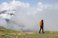 Girl hiking in the Pyrenees, with the mountains in the clouds in the background Royalty Free Stock Photo
