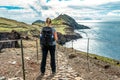 Girl hiking rocky cliffs clear near water of Atlantic Ocean bay Ponta de Sao Lourenco, the island of Madeira, Portugal